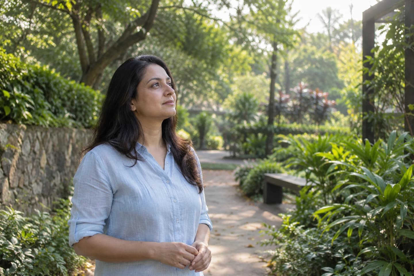 Illustrative photograph of a woman taking a reflective pause outdoors